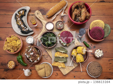mixed colombian and venezuelan food meal spread on wooden restaurant table mixed colombian and venezuelan food meal spread on wooden restaurant table 136613164