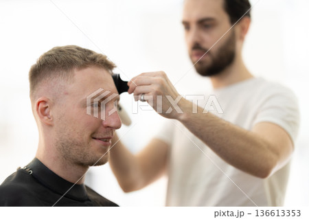 Client receiving a fresh haircut for modern look 136613353