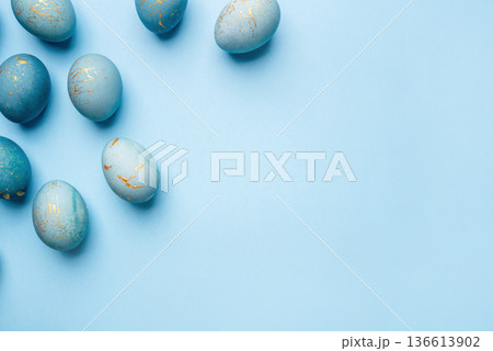 Easter background of eggs painted in blue color. 136613902