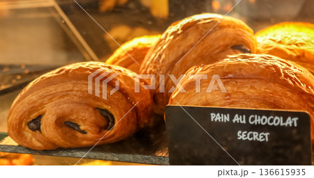 Delicious pain au chocolat pastries for sale in a typical French Parisian bakery display case Delicious pain au chocolat pastries for sale in a typical French Parisian bakery display case 136615935