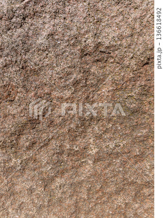 the texture of a stone with multicolored inclusions, a large stone with a rough structure of a red natural stone surface the texture of a stone with multicolored inclusions, a large stone with a rough structure of a red natural stone surface 136618492