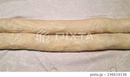 Unbaked homemade strudels on a tablecloth Unbaked homemade strudels on a tablecloth 136619136