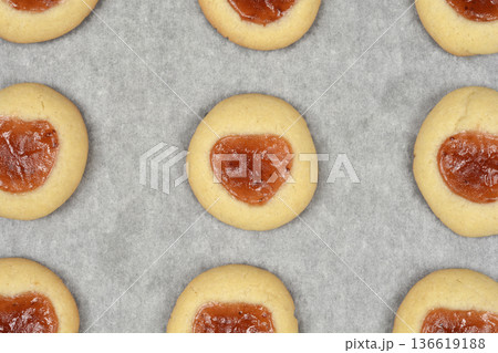 Baked thumbprint cookies with jam filling close up Baked thumbprint cookies with jam filling close up 136619188