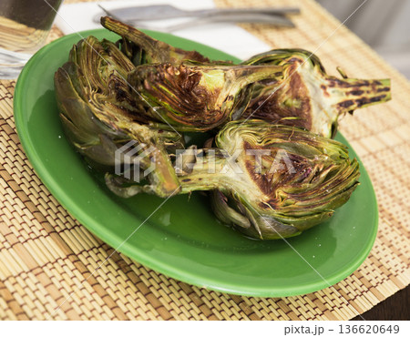 cooked fried halves artichokes on green plate cooked fried halves artichokes on green plate 136620649