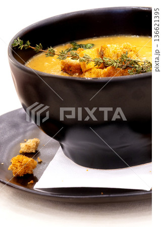 Cream soup with croutons and thyme Cream soup with croutons and thyme 136621395