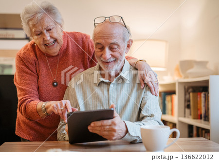 Senior coule working with tablet, having problem with technology. Senior coule working with tablet, having problem with technology. 136622012