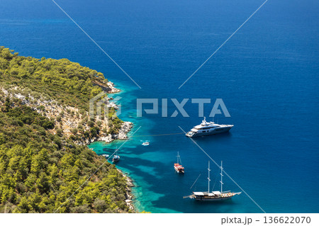 Aerial view of a tranquil bay where several boats 136622070