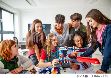 Diverse group of students working on engineering school project. 136622130