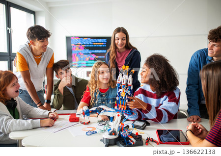 Diverse group of students working on engineering school project. Diverse group of students working on engineering school project. 136622138