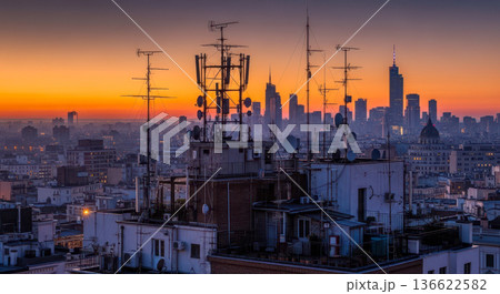 skyline at sunset with telecommunication antennas on rooftop technology concept for 5g network data and global communication urban european cityscape 136622582