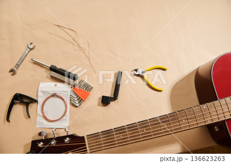 Guitar String Replacement and Maintenance Tools Laid Out for Repair Guitar String Replacement and Maintenance Tools Laid Out for Repair 136623263