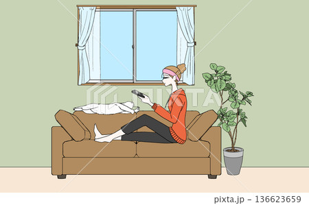 部屋でくつろいでいる猫と女性 136623659