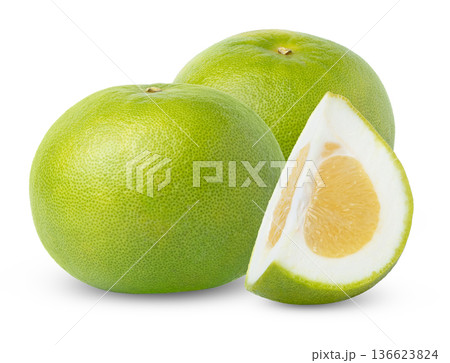 Two fresh oroblanco, pomelo, pomelit or sweetie grapefruit fruits and cut in a slice isolated. 136623824