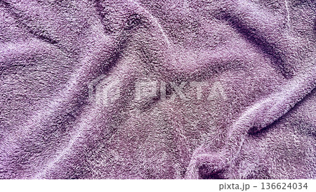 vibrant purple plush fabric texture undulating softly in macro closeup evoking cozy luxury ideal for soothing wallpaper or elegant banner background 136624034