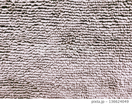 soft beige shag carpet texture macro view with fluffy fibers waving gently evoking cozy home ambiance for neutral wallpaper or design backdrop 136624049
