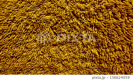 golden yellow terry cloth texture macro closeup with swirling loops and soft warmth for seamless wallpaper or luxury fabric background golden yellow terry cloth texture macro closeup with swirling loops and soft warmth for seamless wallpaper or luxury fabric background 136624059