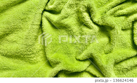 vibrant lime green fluffy towel texture closeup soft rippling folds evoke freshness ideal for spa background wallpaper or copy space banner vibrant lime green fluffy towel texture closeup soft rippling folds evoke freshness ideal for spa background wallpaper or copy space banner 136624146
