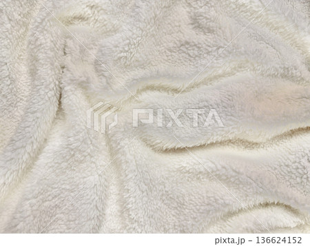 soft white fluffy fleece texture folds gently in creamy waves evoking cozy winter warmth for blanket background wallpaper or apparel design soft white fluffy fleece texture folds gently in creamy waves evoking cozy winter warmth for blanket background wallpaper or apparel design 136624152