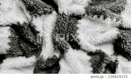 abstract monochrome fluffy fur texture closeup with swirling black white patterns evoking cozy elegance ideal for wallpaper or banner background 136624155