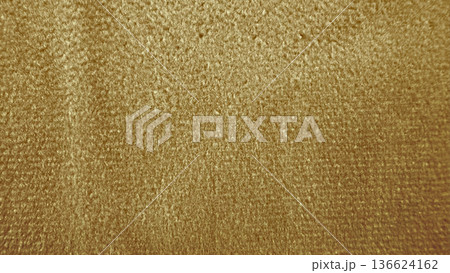 opulent golden velvet texture shimmering with fuzzy fibers in warm glow ideal for luxury wallpaper or elegant banner background 136624162