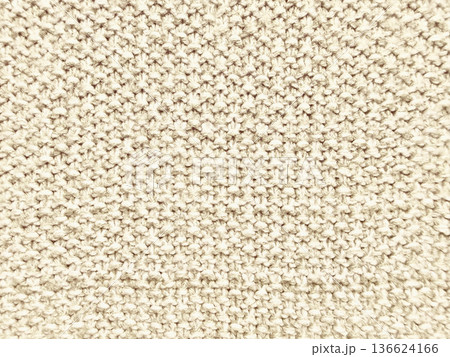 creamy beige knitted wool texture macro closeup evoking cozy warmth and subtle elegance for neutral wallpaper background or textile design banner 136624166