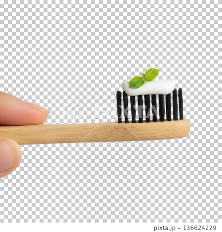 Eco-conscious concept, hand presenting a natural bamboo toothbrush with fresh mint toothpaste, isolated for dental hygiene and green lifestyle themes 136624229