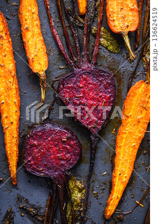 Baked beetroot and carrots seasoned with herbs and spices Baked beetroot and carrots seasoned with herbs and spices 136624519