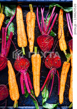 Beetroot and carrots prepared for roasting with oil and spices Beetroot and carrots prepared for roasting with oil and spices 136624520