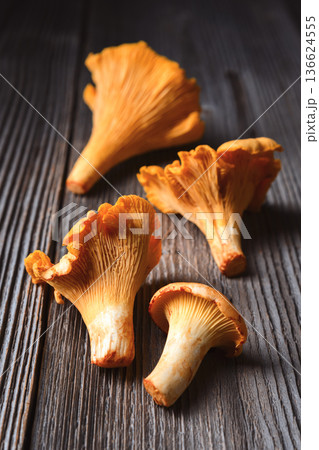 Chanterelle mushrooms on old wooden table Chanterelle mushrooms on old wooden table 136624555