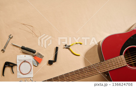 Guitar String Maintenance and Repair Tools With Acoustic Guitar On Work Surface Guitar String Maintenance and Repair Tools With Acoustic Guitar On Work Surface 136624708