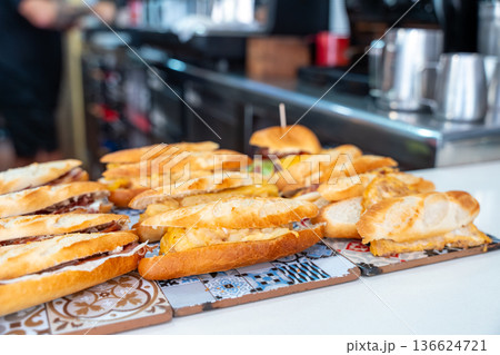 Spanish sandwiches bocadillos displayed on a tapas bar counter 136624721