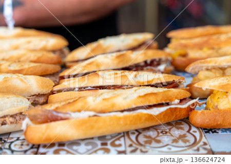 Spanish bocadillos with ham, tortilla, and tuna fillings 136624724