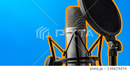Recording a podcast with a professional microphone and pop filter in a bright studio Recording a podcast with a professional microphone and pop filter in a bright studio 136624854