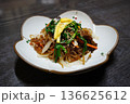 Traditional Korean Japchae, Stir-fried Glass Noodles with Mixed Vegetables, Spinach, Carrots, and Egg Garnish 136625612