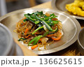 Traditional Korean Japchae, Stir-fried Glass Noodles with Mixed Vegetables, Spinach, Carrots, and Egg Garnish 136625615