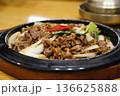Sizzling Korean Bulgogi Beef with Sliced Onions and Green Onions on Hot Stone Plate 136625888
