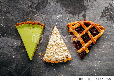 Three assorted pie slices on dark background Three assorted pie slices on dark background 136630290