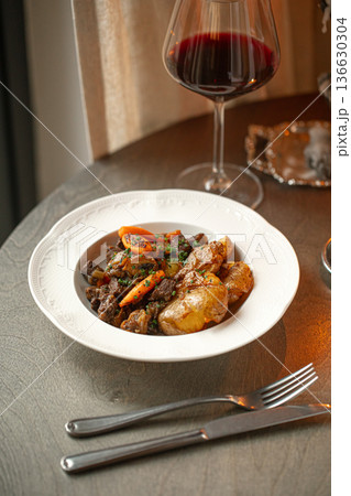 French beef bourguignon with wine and potatoes 136630304
