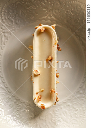 Creamy mousse dessert with nuts on plate Creamy mousse dessert with nuts on plate 136630319
