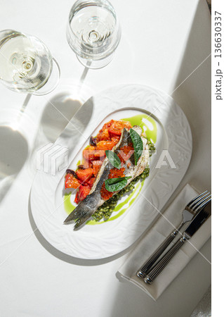 Seared fish fillet with vegetables and green sauce Seared fish fillet with vegetables and green sauce 136630337