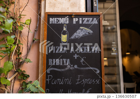Restaurant menu board with pizza and drinks outside Italian cafe 136630507