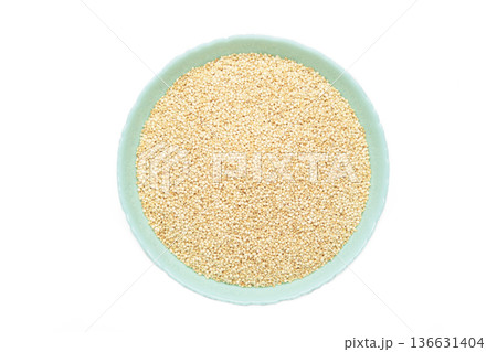 Organic white quinoa seeds in blue plate isolated on white background. 136631404