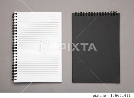 White and black spiral notebooks mockup on grey background. White and black spiral notebooks mockup on grey background. 136631411