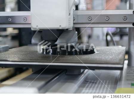 3D printer. 3D printer printing object close-up. 3D printer printing model black color. Working 3D printer. Concept printing technology. New modern additive progressive technology. FDM technologies 3D printer. 3D printer printing object close-up. 3D printer printing model black color. Working 3D printer. Concept printing technology. New modern additive progressive technology. FDM technologies 136631472