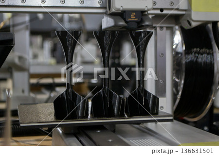 3D printer. 3D printer printing object close-up. 3D printer printing model black color. Working 3D printer. Concept printing technology. New modern additive progressive technology. FDM technologies 136631501
