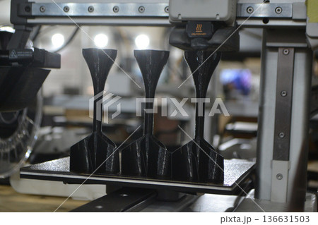 3D printer. 3D printer printing object close-up. 3D printer printing model black color. Working 3D printer. Concept printing technology. New modern additive progressive technology. FDM technologies 136631503