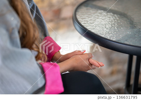 Close-up of a woman's hands with elegant pink-tipped manicured nails Close-up of a woman's hands with elegant pink-tipped manicured nails 136631795