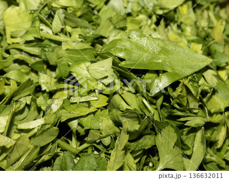 Close up of chopped fresh green herbs basil coriander parsley Close up of chopped fresh green herbs basil coriander parsley 136632011