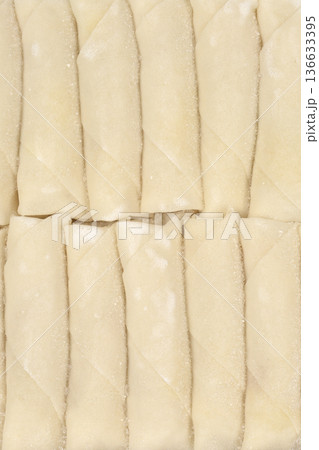 Row of frozen spring rolls Row of frozen spring rolls 136633395