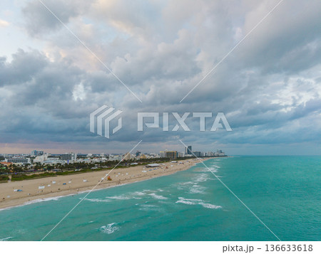 Aerial view of Miami city by the coast. Miami skyline with oceanfront skyscrapers. Scenic Miami panorama of Florida famous coastline. Drone shot of Miami above the shore. Aerial view of Miami city by the coast. Miami skyline with oceanfront skyscrapers. Scenic Miami panorama of Florida famous coastline. Drone shot of Miami above the shore. 136633618